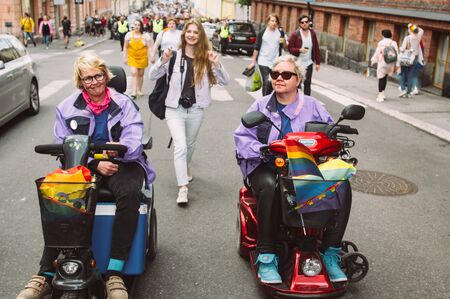 Helsinki, Finland - June 29, 2019: Disabled women in electric invalid wheelchair on Helsinki pride festival on streetのeditorial素材