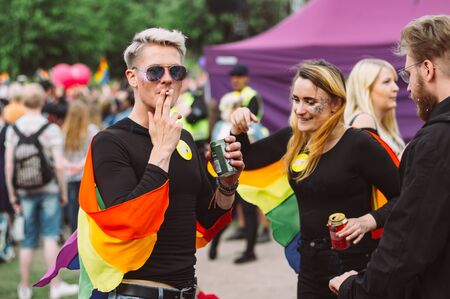 Helsinki, Finland - June 29, 2019: People smoke cigarettes and drink beer on picnic on Helsinki Pride festival in Kaivopuisto public parkのeditorial素材