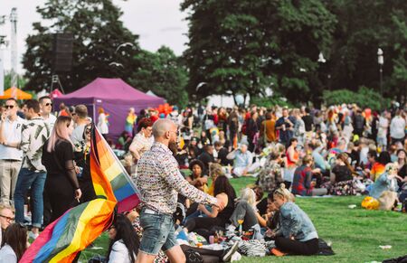 Helsinki, Finland - June 29, 2019: Man  with big rainbow flag  on Helsinki Pride festival in Kaivopuisto public parkのeditorial素材