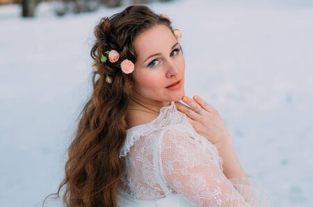 Portrait of bride in winter with  roses in hairの写真素材
