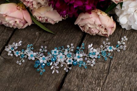 Beautiful white and blue jewelry with bouquet of peoniesの写真素材