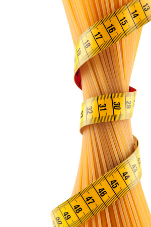 Bunch of spaghetti strapped meter on a white background symbolizes the importance of proper nutritionの写真素材
