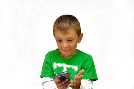 suprised young boy with mobile phone, cell phone,の写真素材