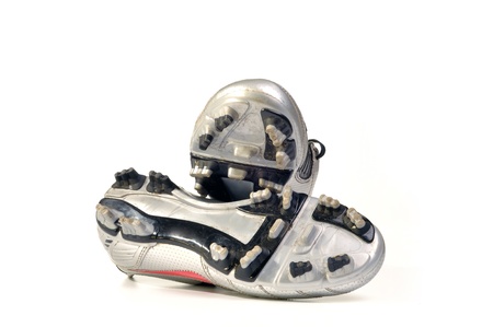 used soccer, football shoes isolated on a white backgroundの写真素材