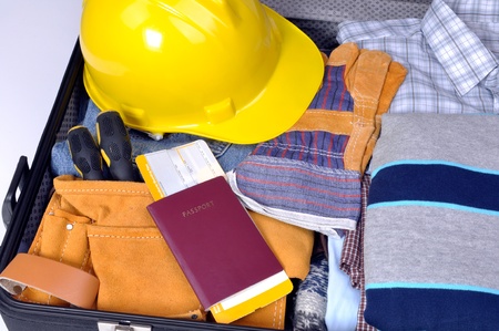 travel for money, job tourism, suitcase with clothes of the workerの写真素材