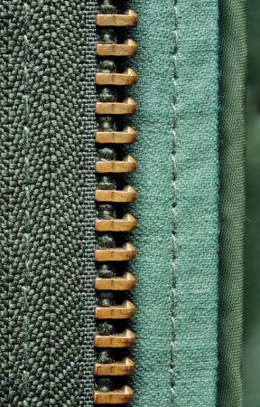 half of the zipper in olive green jacketの写真素材