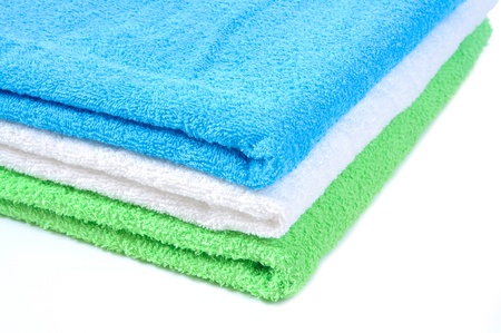 stacked colorful towels on a white backgroundの写真素材