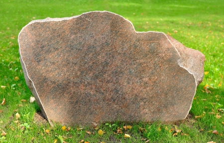 an array of cut stone on the grass, place for textの写真素材