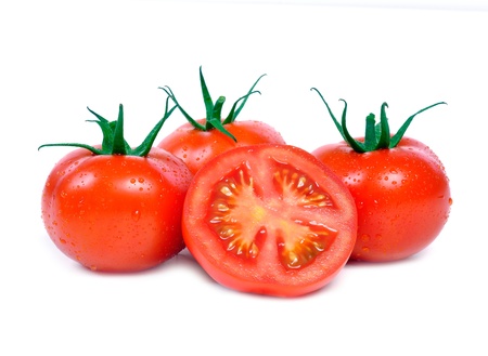 Three tomatoes and one half on white background の写真素材