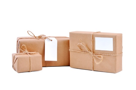 Three brown packages with blank labels on whiteの写真素材
