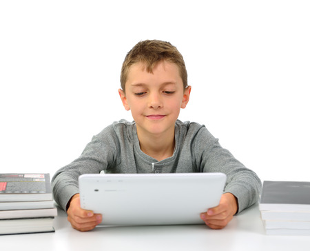 Boy reading an e-book instead of booksの写真素材