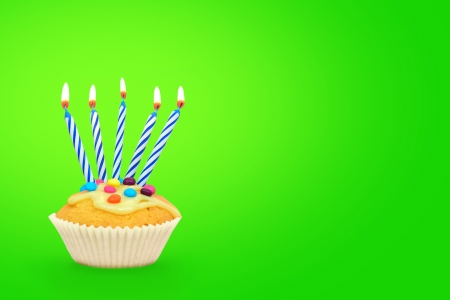 Birthday cupcake with candles ongreen background Text space の写真素材