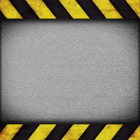 Background with warning stripes and metal rusty plateの写真素材