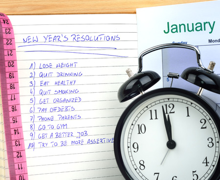 New Year's resolutions with alarm clock and measureの写真素材