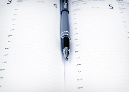 Pen and schedule in the calendar の写真素材