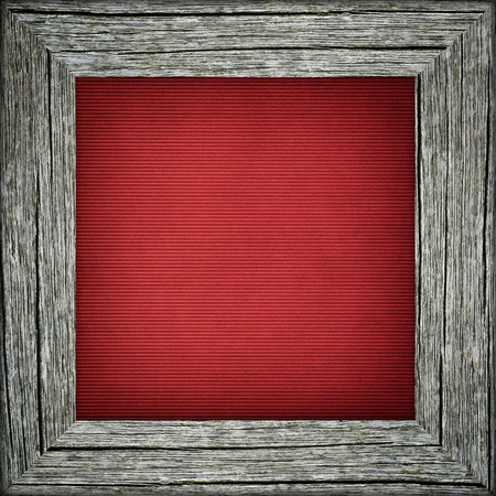 Old raw wooden frame with red striped canvasの写真素材