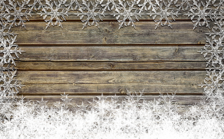 Wooden Christmas background with snow flakesの写真素材