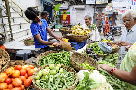 Udaipur, India, september 12, 2010: Young men selling vegetables and fruits on a localstreet market in Udaipur.のeditorial素材
