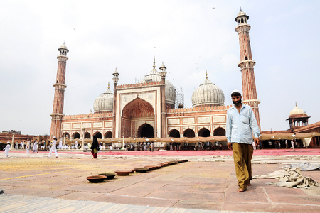 Delhi, India, september 3, 2010: Muslim men walking on in front of mosque Masjid in Delhi, India.のeditorial素材