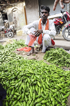 Varanasi, India, september 19, 2010: Young man selling vegetables on a local market.のeditorial素材