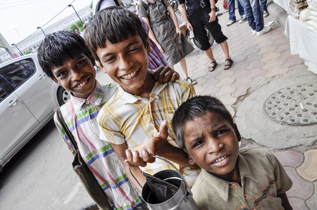 Amritsar, India, September 4, 2010: Tree indian boys begging on a street.