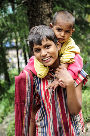 Dharamsala, India, september 6, 2010: Indian siblings smiling on a street od Dharamsala.のeditorial素材