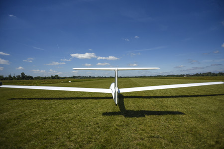 Sailplane landing on a grass, sunny day in Szczecin.の写真素材