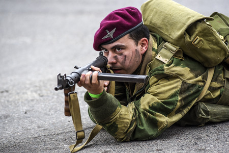 Gryfino, Poland, 23 september 2017: Historical reconstruction of the battle at Arnhem, a British parachutist aiming with a rifle.のeditorial素材