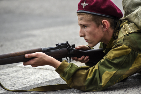 Gryfino, Poland, 23 september 2017: Historical reconstruction of the battle at Arnhem, a British parachutist aiming with a rifle.のeditorial素材