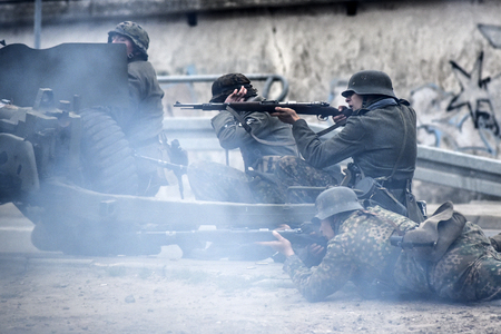 Gryfino, Poland, 23 september 2017: Historical reconstruction of the battle at Arnhem, a German soldier aiming with a rifle.のeditorial素材