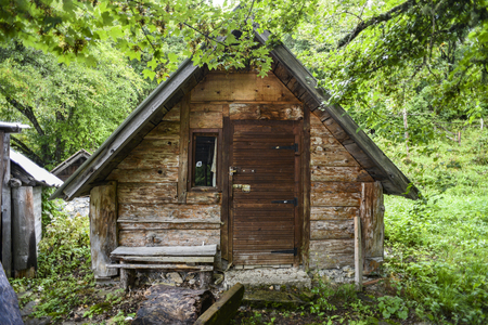 Old wooden small abandoned house in the woods.の写真素材