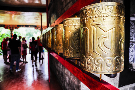 Tibetan prayer wheels in monastery in India.