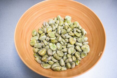 Boiled broad beans in a bamboo bowl.