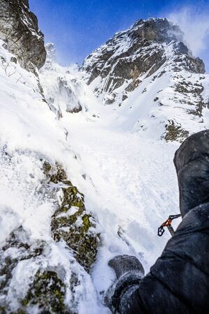 Climber on the winter mountain landscape in the Polish and Slovak Tatra mountains.