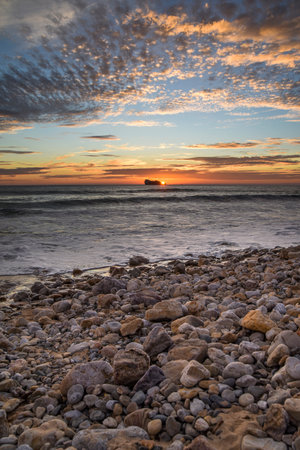 Sunset on the beach on the coast of France over the Atlantic Ocean, sea landscape. Plage de Pen Hat in France.の写真素材