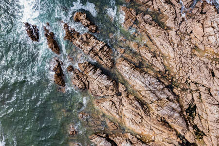 The rocky coast of France over the Atlantic Ocean, viewed from the drone. A beautiful sea landscape.