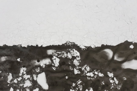 The texture of a frozen lake and pieces of floating ice in the water. Winter landscape from a drone.