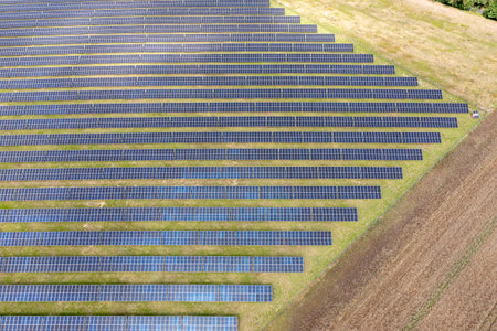 Photovoltaic farm. Photovoltaic panels in a field, view from a drone.