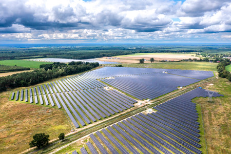 Photovoltaic farm. Photovoltaic panels in a field, view from a drone.
