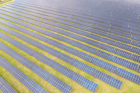 Photovoltaic farm. Photovoltaic panels in a field, view from a drone.