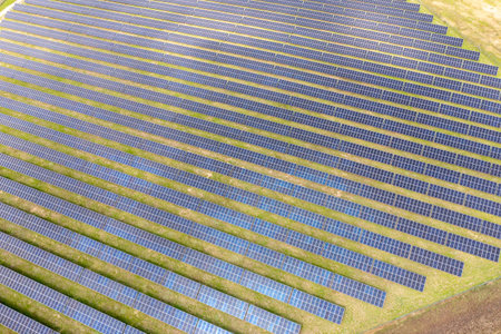 Photovoltaic farm. Photovoltaic panels in a field, view from a drone.