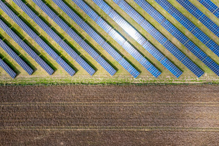 Photovoltaic farm. Photovoltaic panels in a field, view from a drone.の写真素材