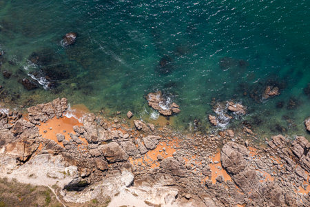 Beautiful ocean landscape from a drone. Rocks, turquoise water, and beach. Vacation travel.