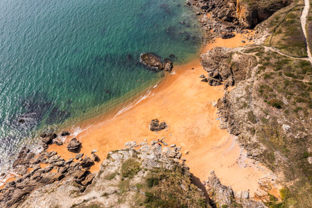 Beautiful ocean landscape from a drone. Rocks, turquoise water, and beach. Vacation travel.