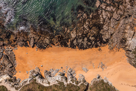 Beautiful ocean landscape from a drone. Rocks, water, and beach. Vacation travel.