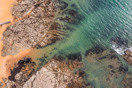 Beautiful ocean landscape from a drone. Rocks, turquoise water, and beach. Vacation travel.の写真素材