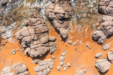 Beautiful ocean landscape from a drone. Rocks, turquoise water, and beach. Vacation travel.