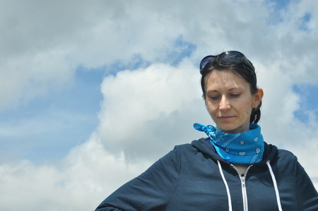 The woman conversing and thoughtful. Girl with earrings. Smile and satisfaction.の写真素材