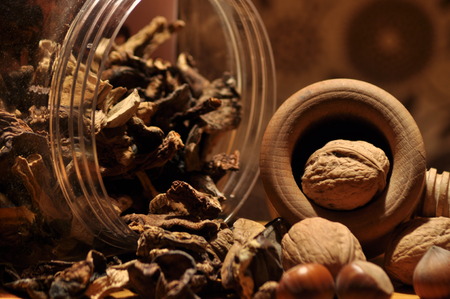 Dried mushrooms spilling from the container. Food ingredients. Forest fruits. Autumn harvest.