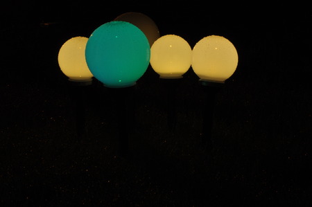 Lanterns lit in the garden. Night and the glowing ballsの写真素材